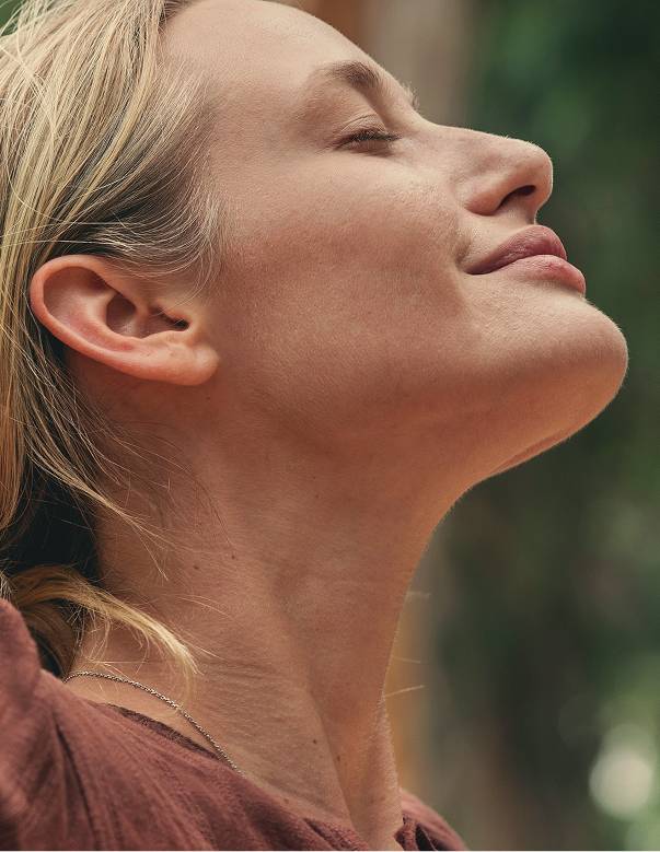 Blonde woman takes in a breath of fresh air.