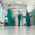 Floor level view of ER room with doctors in scrubs.