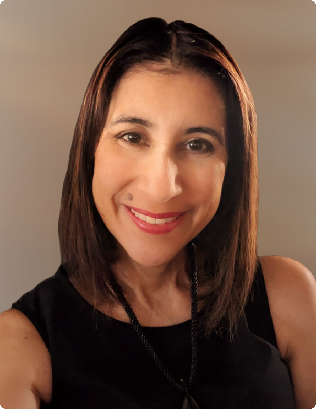 Headshot of woman wearing black dress in front of white background.